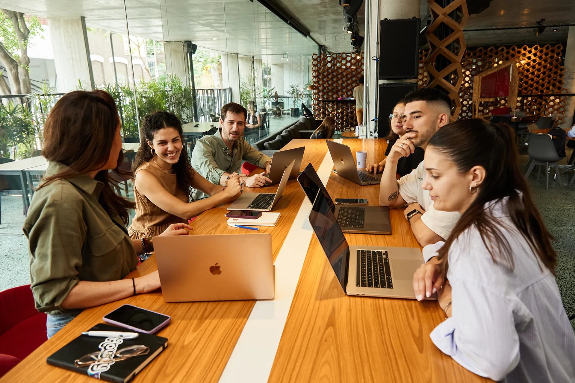 People working and smiling around a laptop